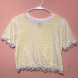 White and yellow stripes pattern with flower design at the bottom and on sleeves